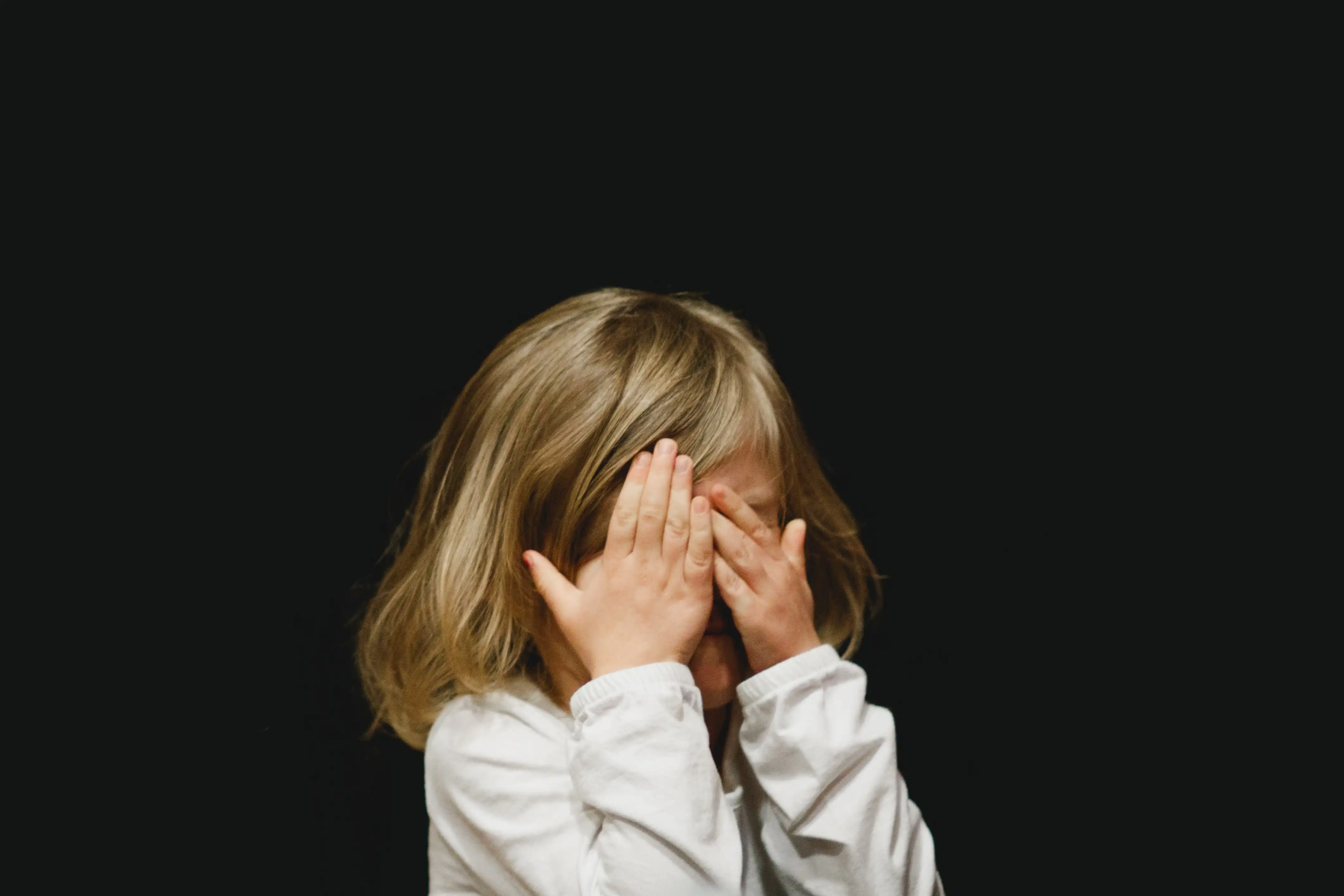 gIrl covering her face